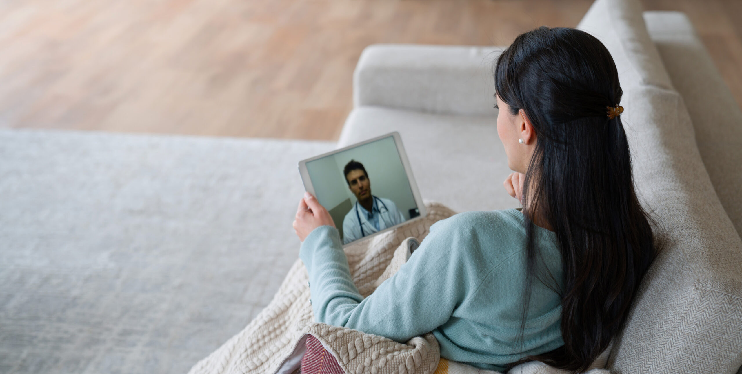 woman at home talking to her doctor on a video call - healthcare and medicine concepts